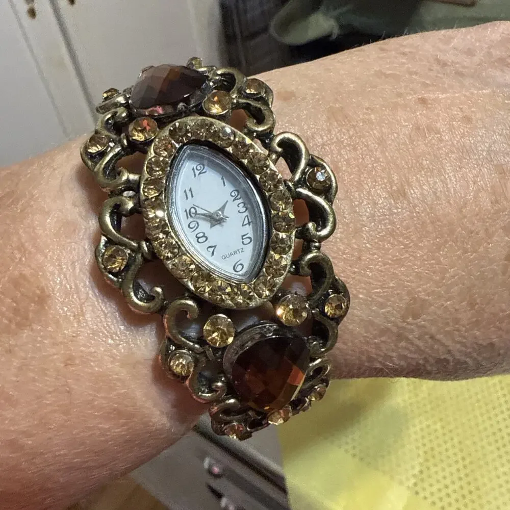 Vintage Gold-tone ornate cuff watch with large red and orange faux gemstones.